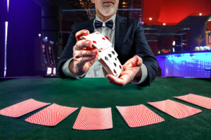 Croupier or casino dealer at gambling club or casino. Close up o