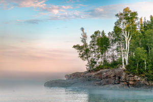 The mist rolls in during sunset on the north shore of Lake Super