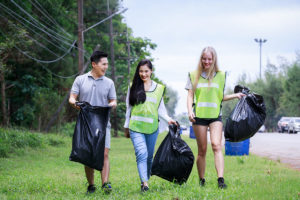 CSR activity. Corporate Social Responsibility. Three volunteers,